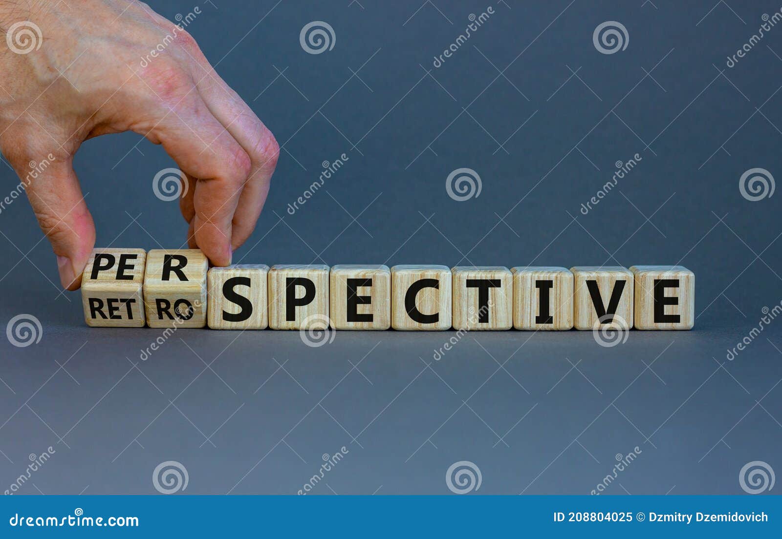 businessman hand turns cubes and changes word 'retrospective' to 'perspective'. beautiful