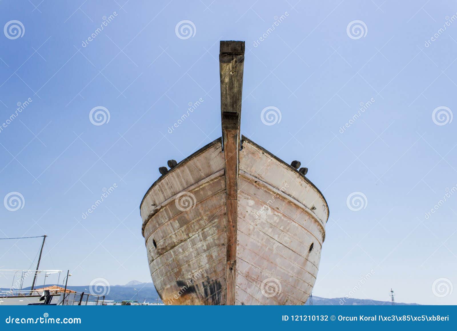 perspective shot of front side fishing boat on ground for painting of trunk at lesvos, kalloni