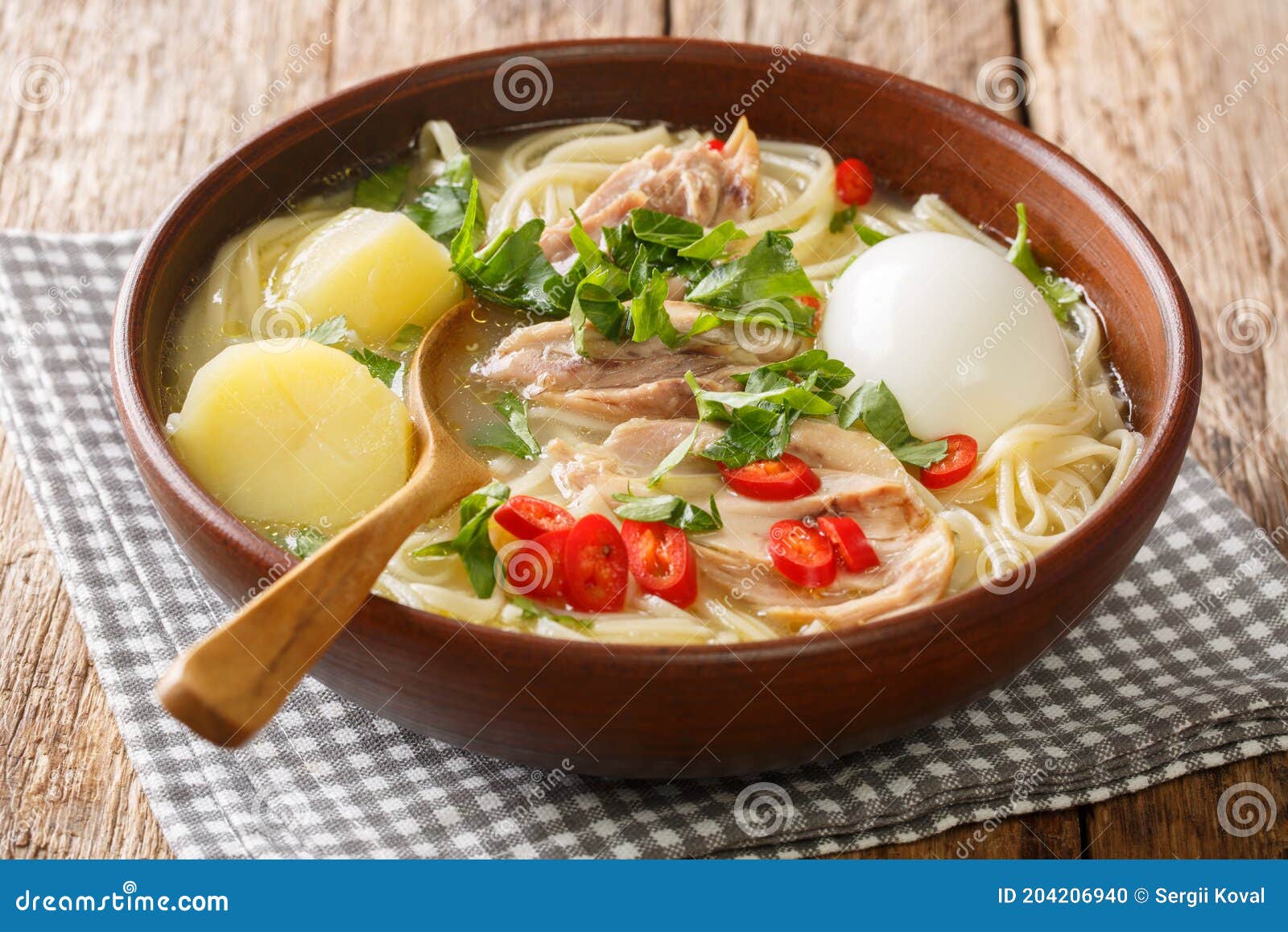 peruvian caldo de gallina chicken soup closeup in the plate. horizontal