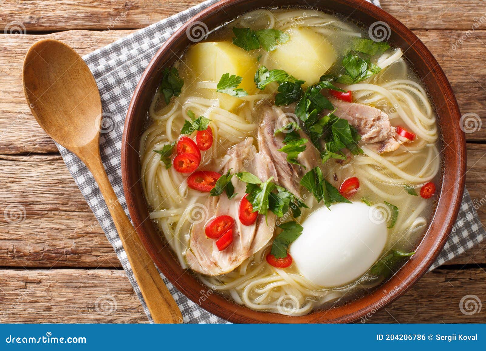 peruvian caldo de gallina chicken soup closeup in the plate. horizontal top view