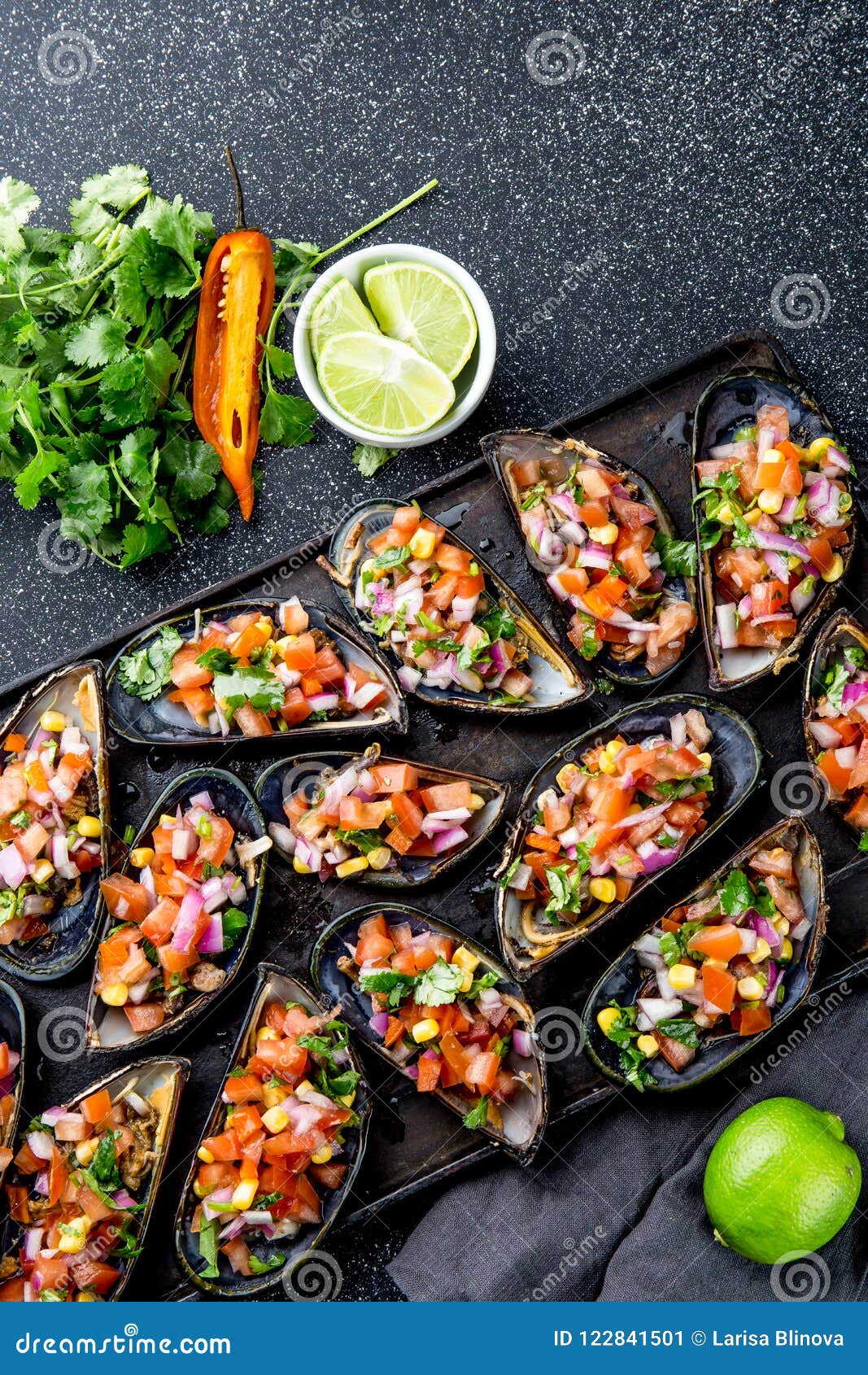 peruvian food. choros a la chalaca. big mussels, choros zapatos seasoned with purple onion, tomatoes, corn and lemon