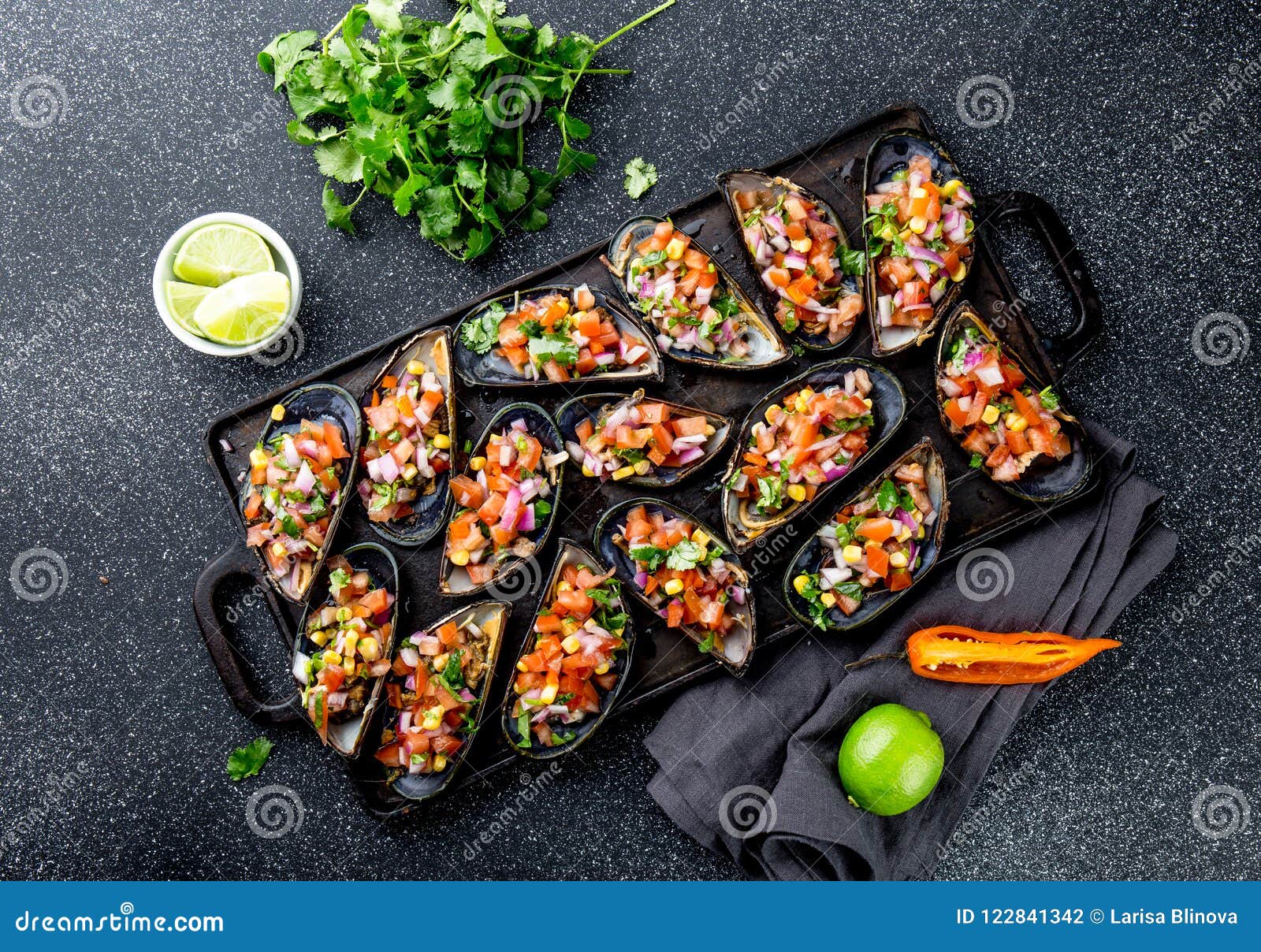 peruvian food. choros a la chalaca. big mussels, choros zapatos seasoned with purple onion, tomatoes, corn and lemon