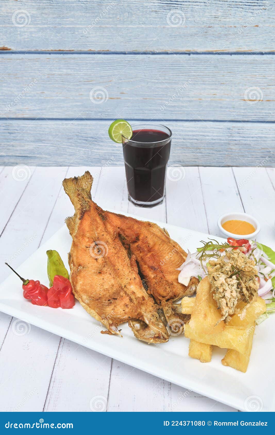 peruvian food, typical dish fried trout, with rice, yucca and salad, sective focus