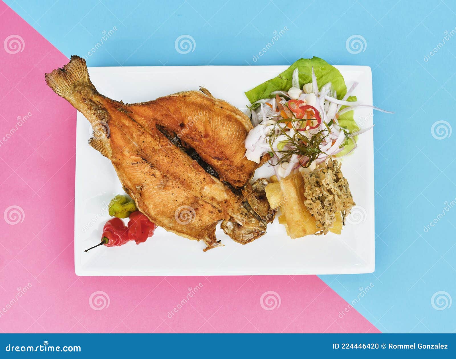 peruvian food, typical dish fried trout, with rice, yucca and salad, sective focus