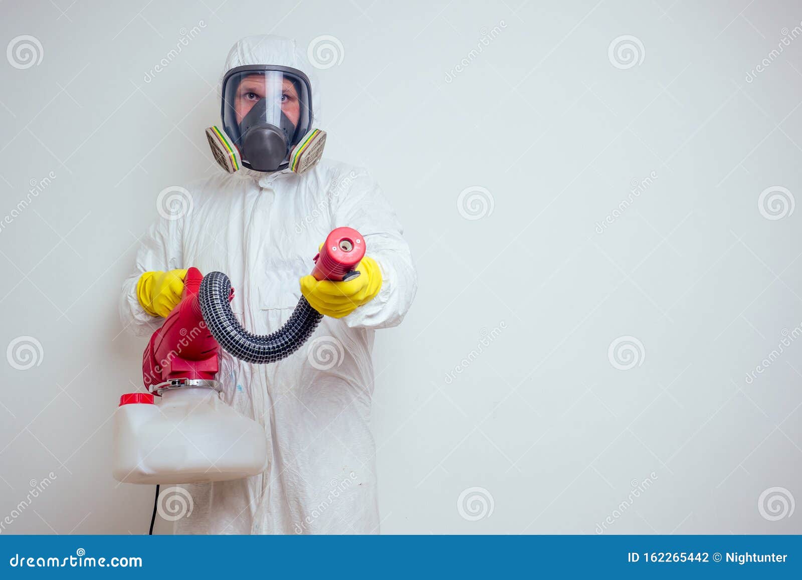 pest control worker spraying pesticides with sprayer in apartment copy spase white walls background