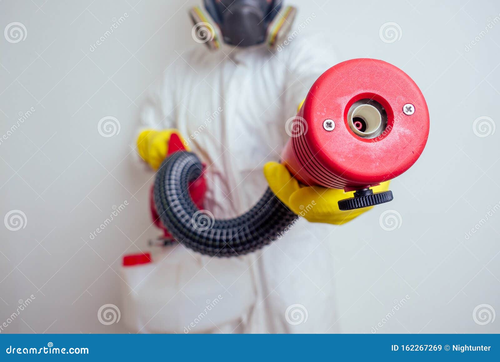 pest control worker spraying pesticides with sprayer in apartment copy spase white walls background