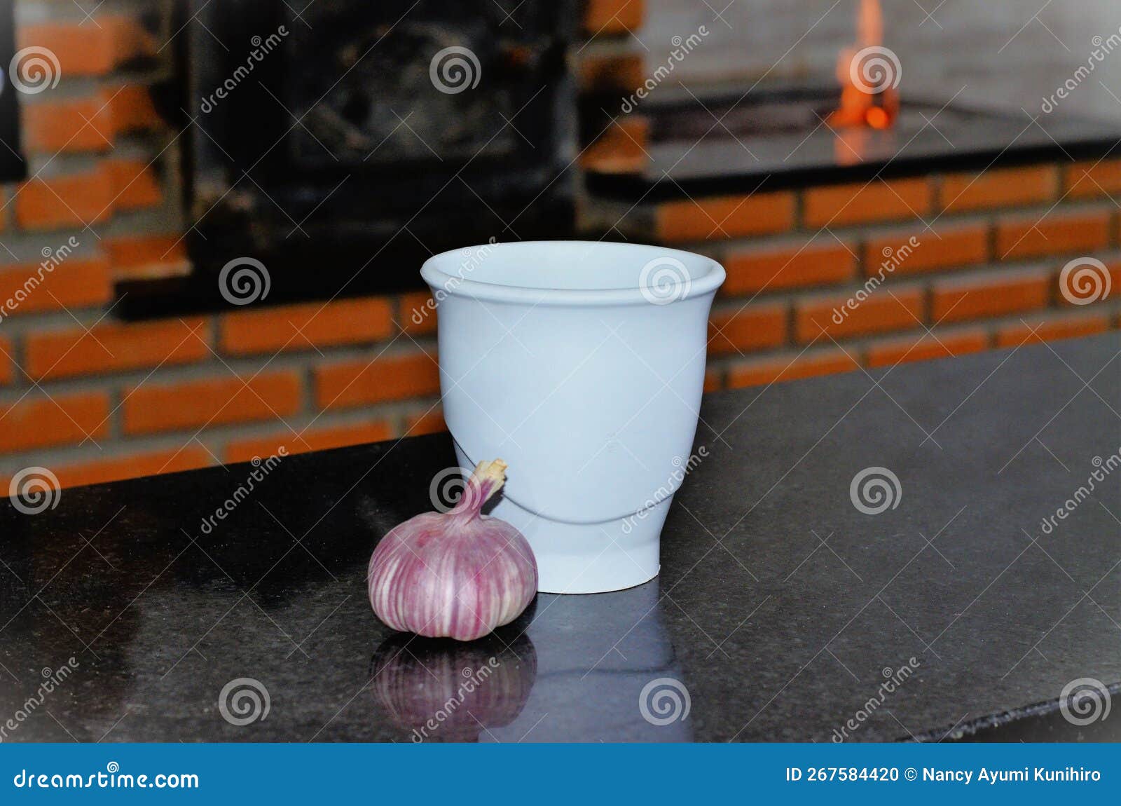 pestle and garlic cup on table