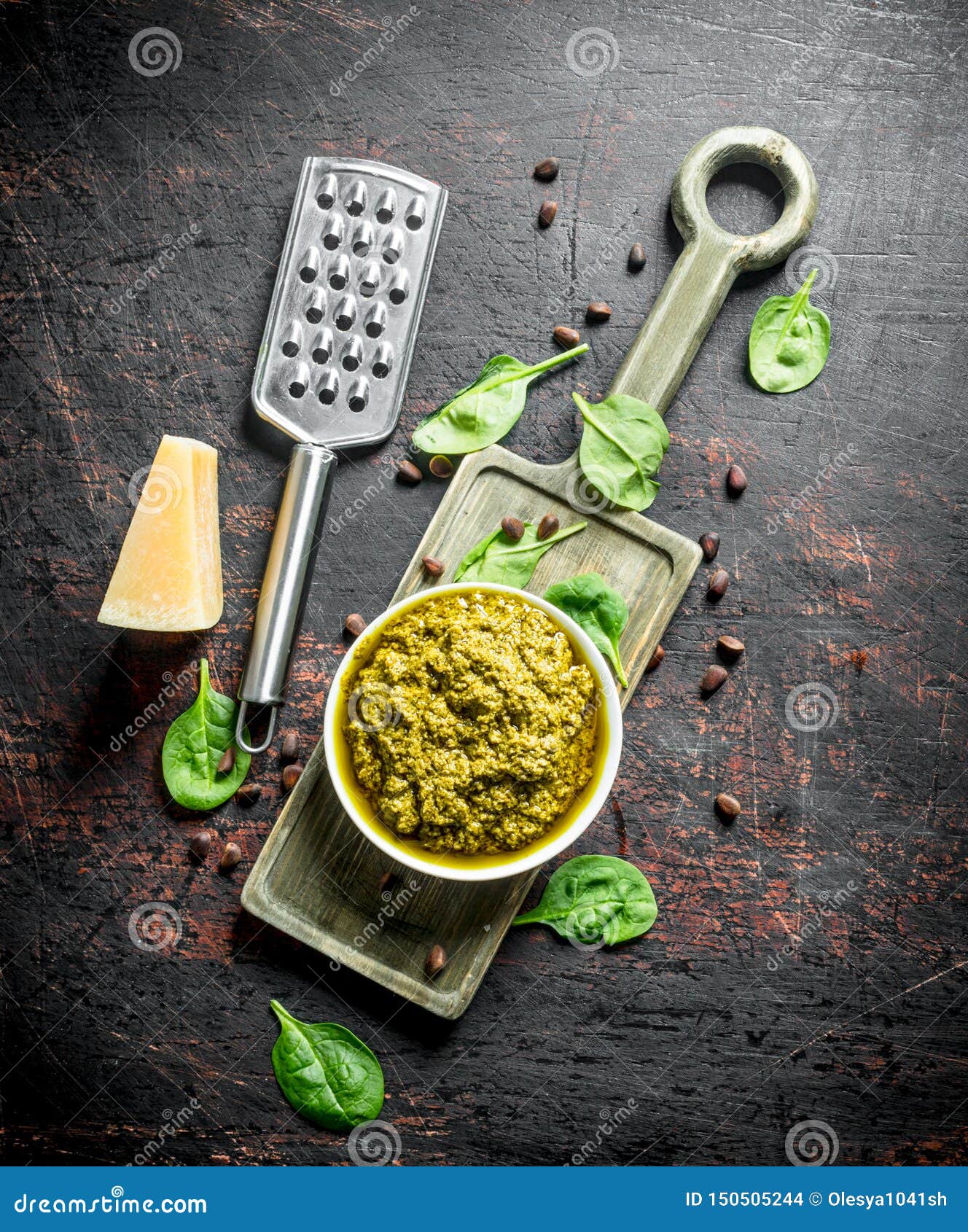 Pesto Sauce on a Cutting Board with Parmesan, Pine Nuts and Basil Stock