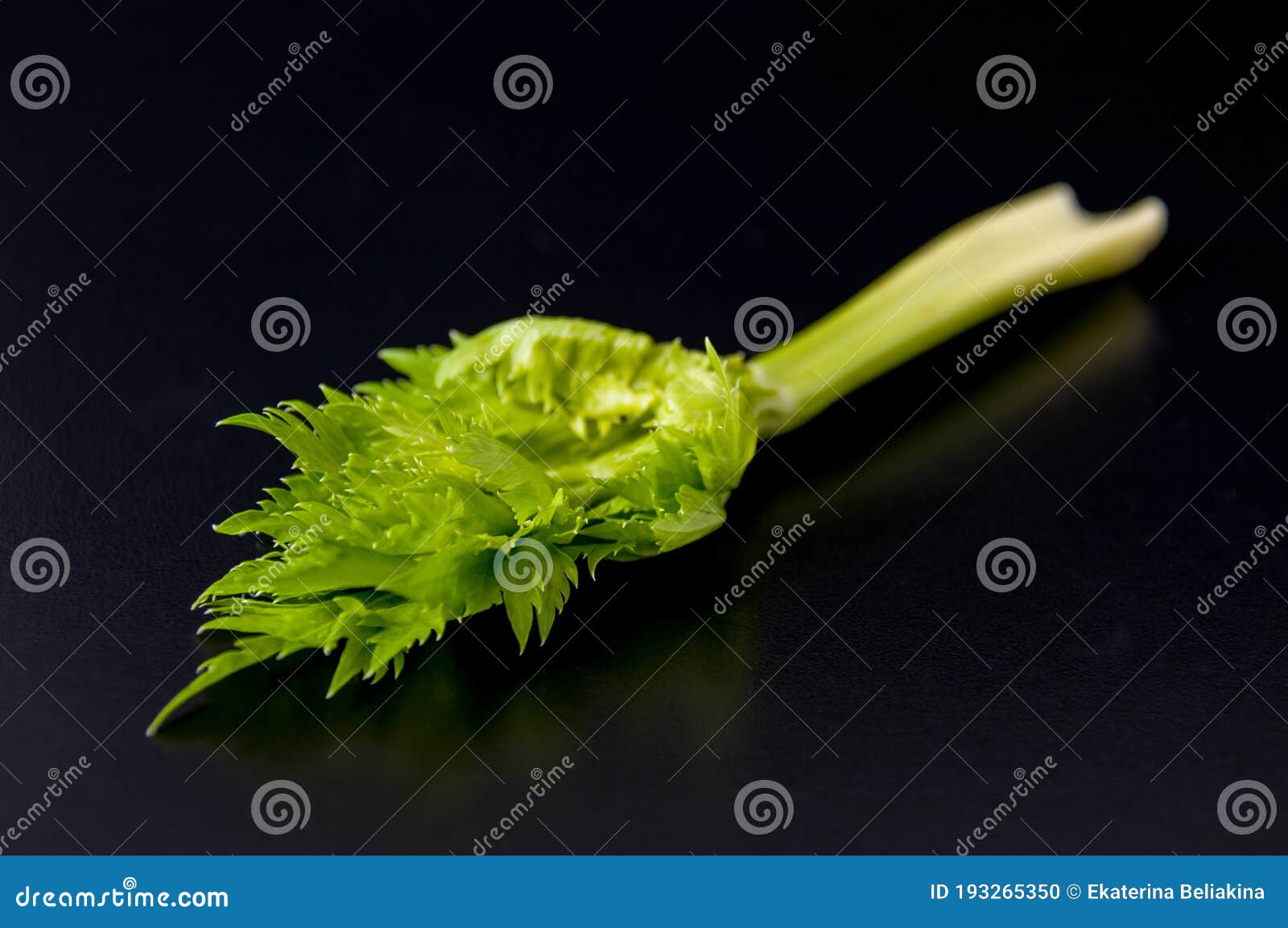 petiolate celery on a black table background