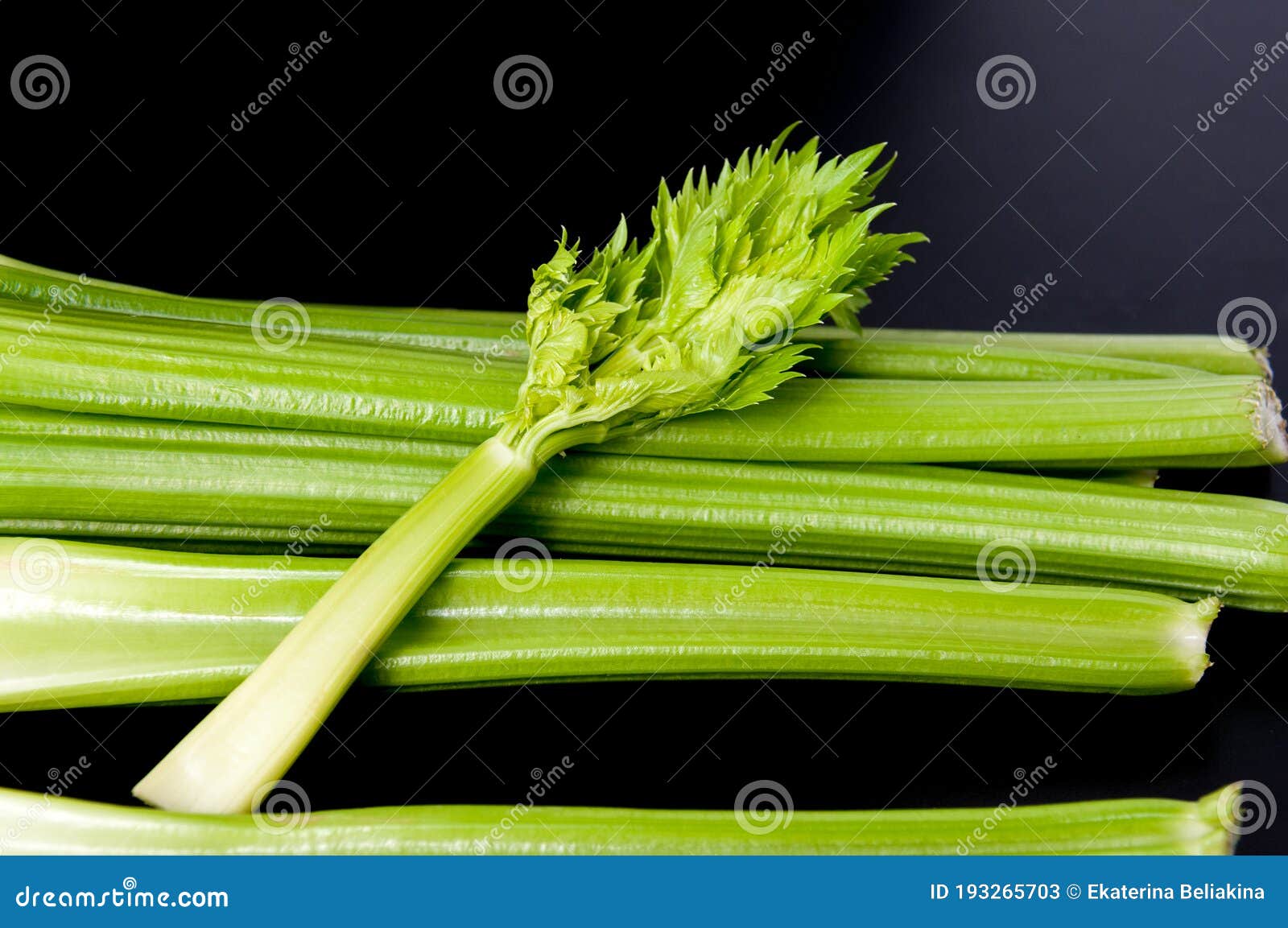 petiolate celery on a black table background