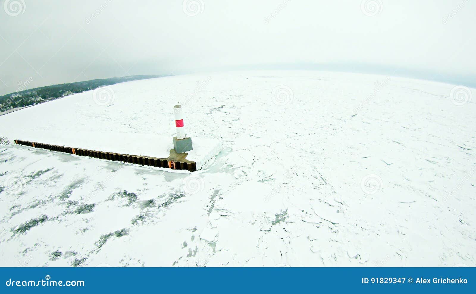 petoskey harbor breakwater in spring with frozen lake