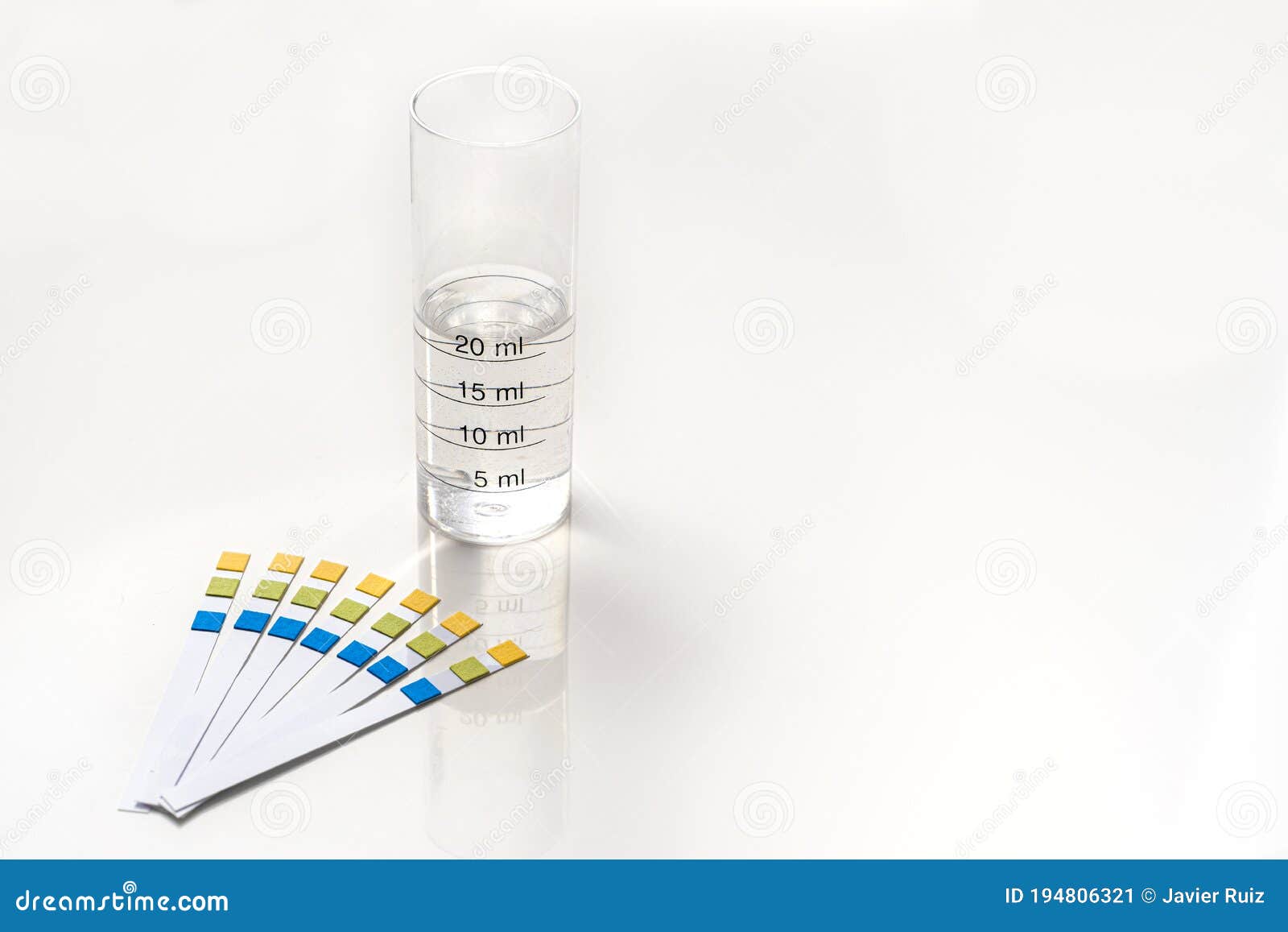 Ph Test Strips with a Test Tube Graduated with Wather Stock Image