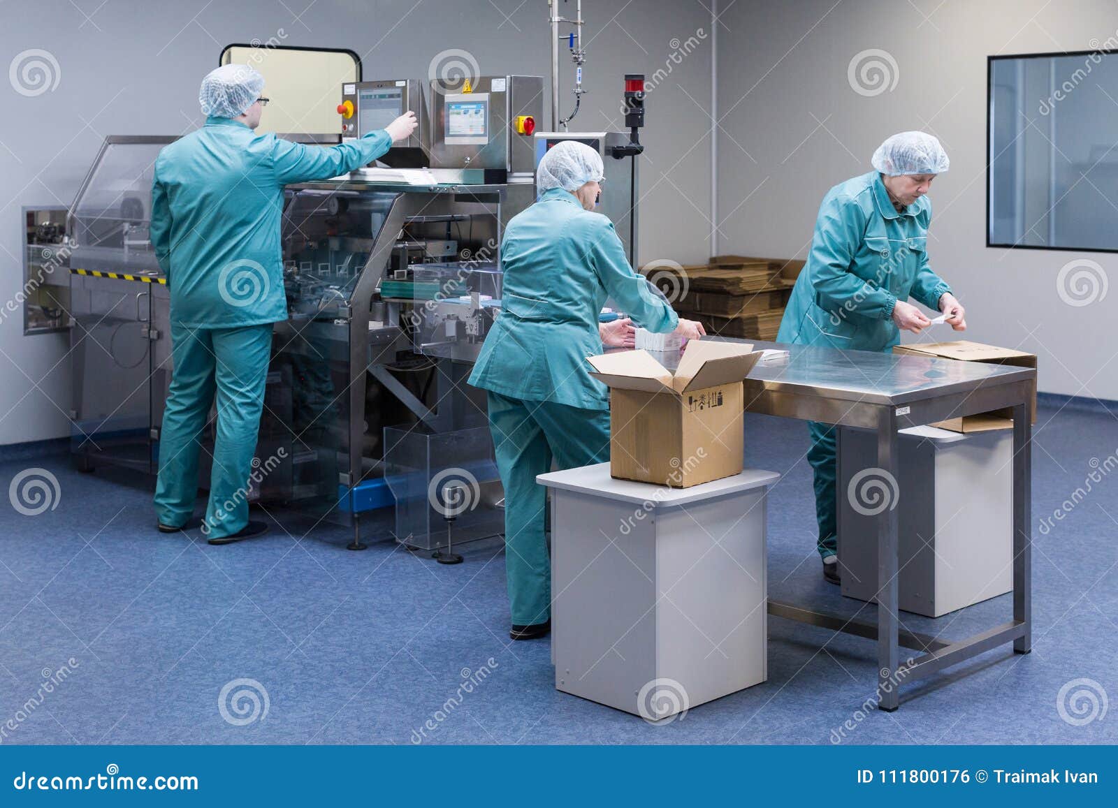 Pharmaceutical Factory Workers in Sterile Environment Stock Photo