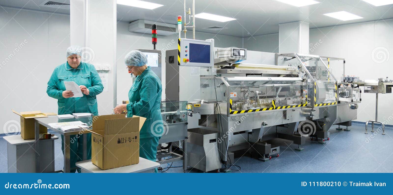 Pharmaceutical Factory Workers in Sterile Environment Stock Photo