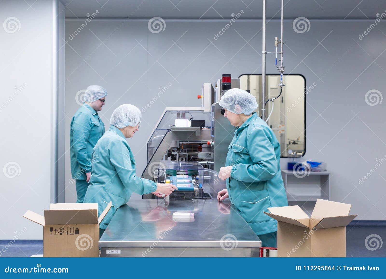 Pharmaceutical Factory Workers in Sterile Environment Stock Photo