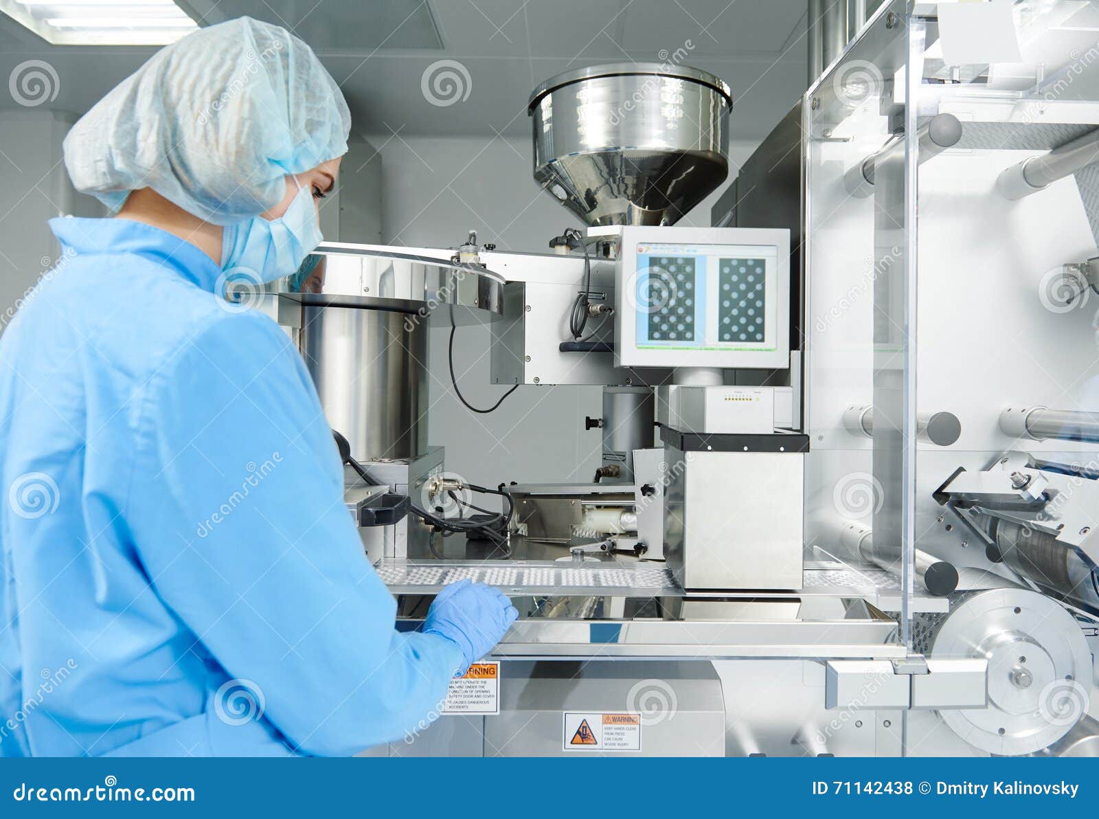 pharmaceutics. pharmaceutical worker operates blister packaging machine