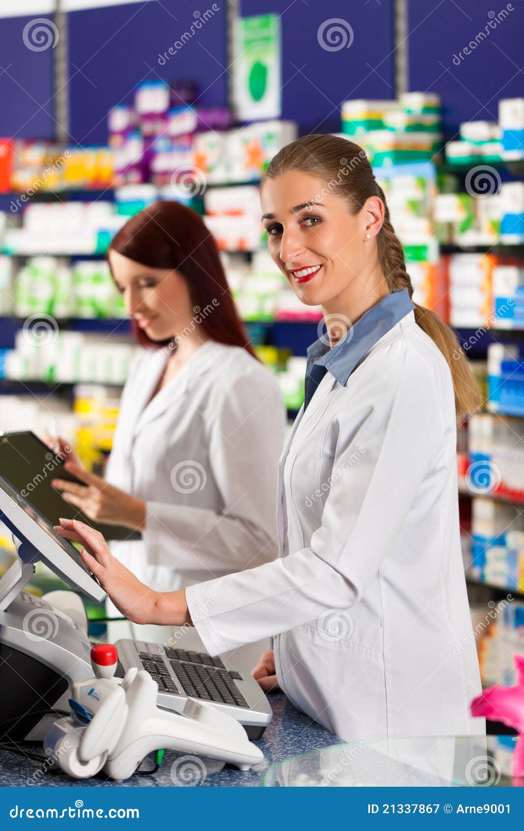 Pharmacist with Assistant in Pharmacy Stock Image Image of encash