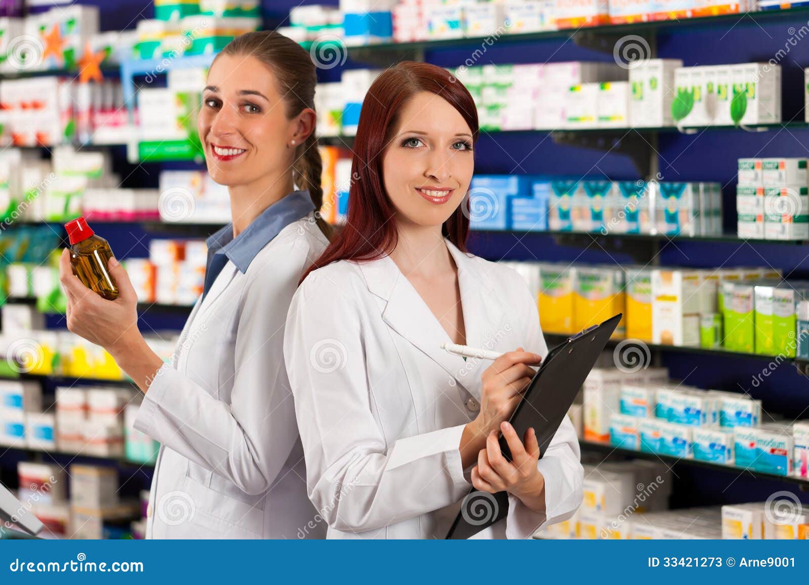 Pharmacist with Assistant in Pharmacy Stock Image Image of friendly