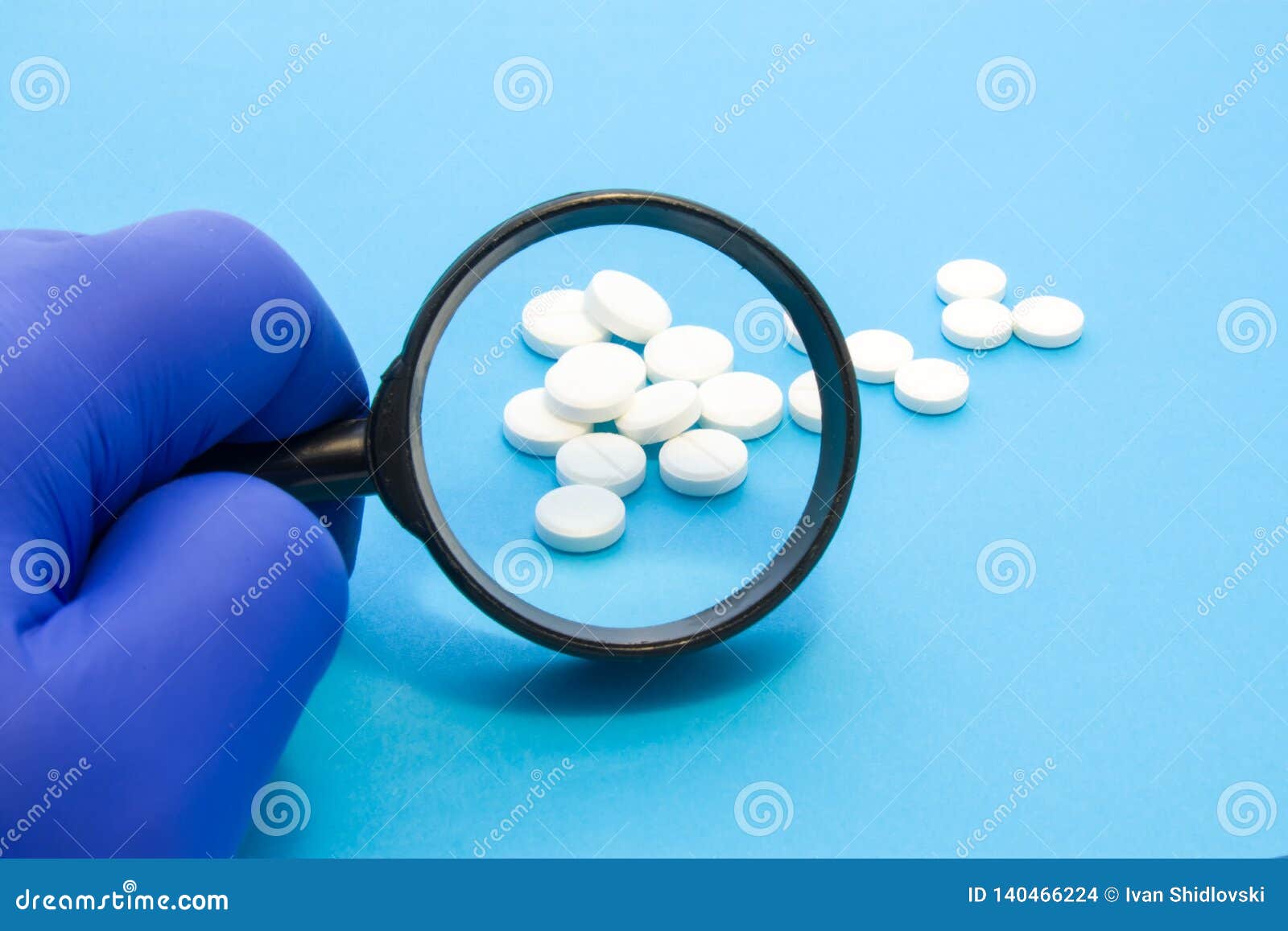 pharmacist or expert on pharmaceutical inspection identifies pills. testing, verification and determining pharmaceutical counterfe