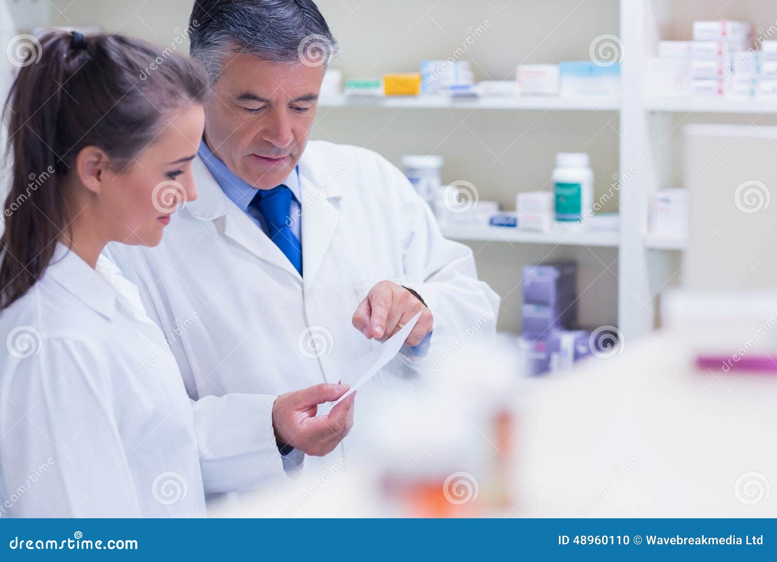 Pharmacist Explaining a Prescription To His Trainee Stock Photo Image