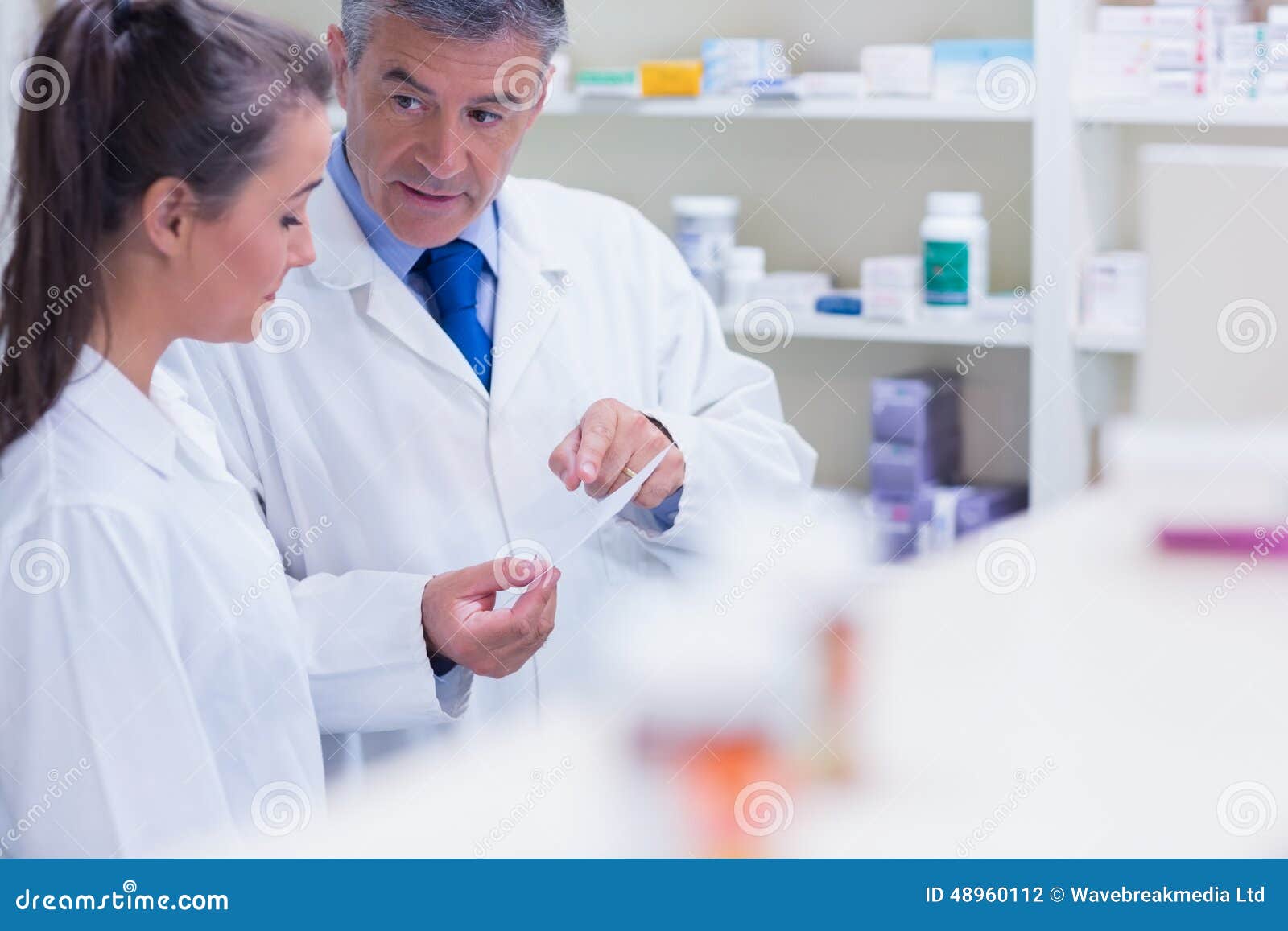 Pharmacist Explaining a Prescription To His Trainee Stock Photo Image