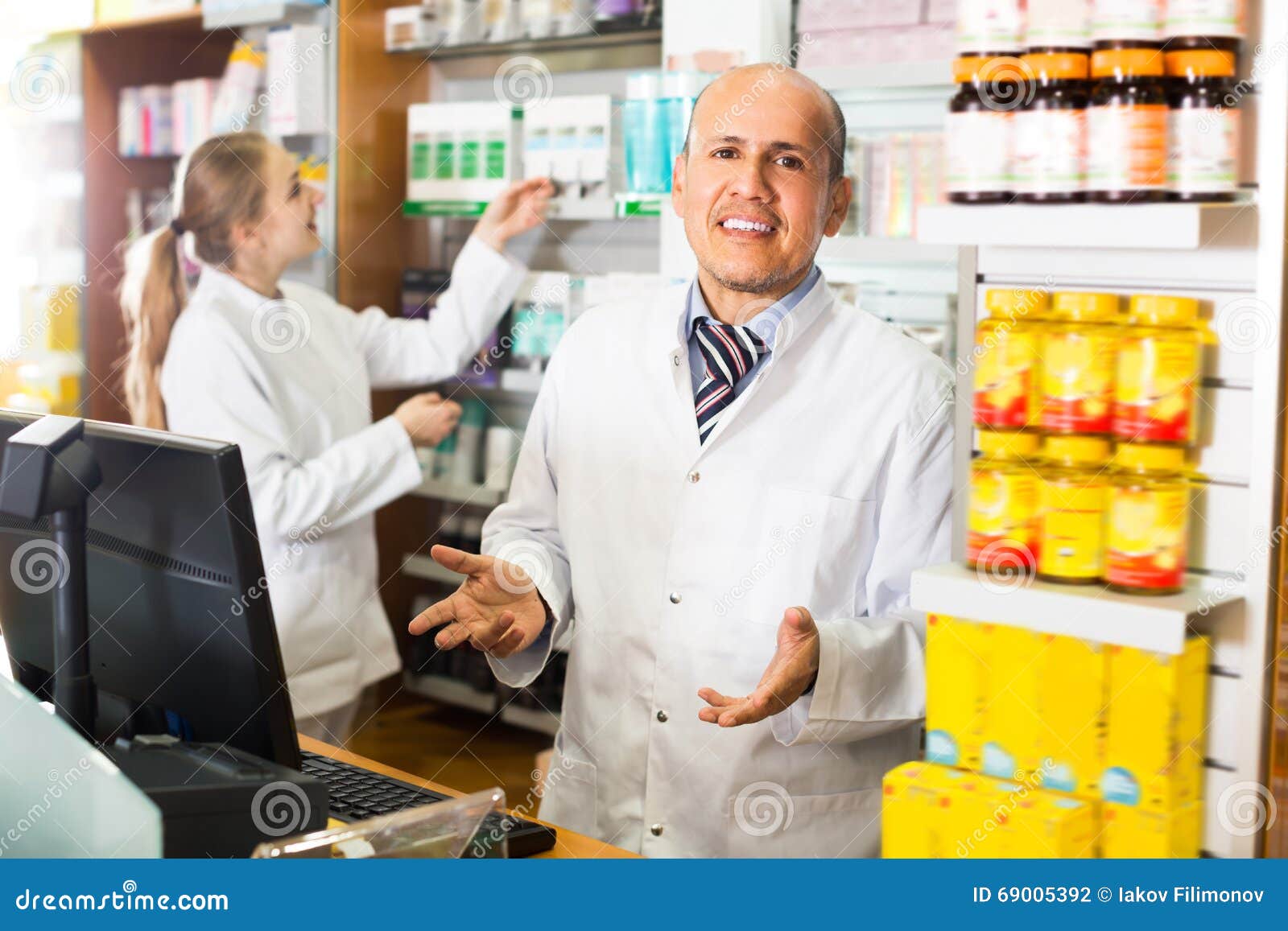 Pharmacist and Female Pharmacy Assistant Helping Stock Photo Image of