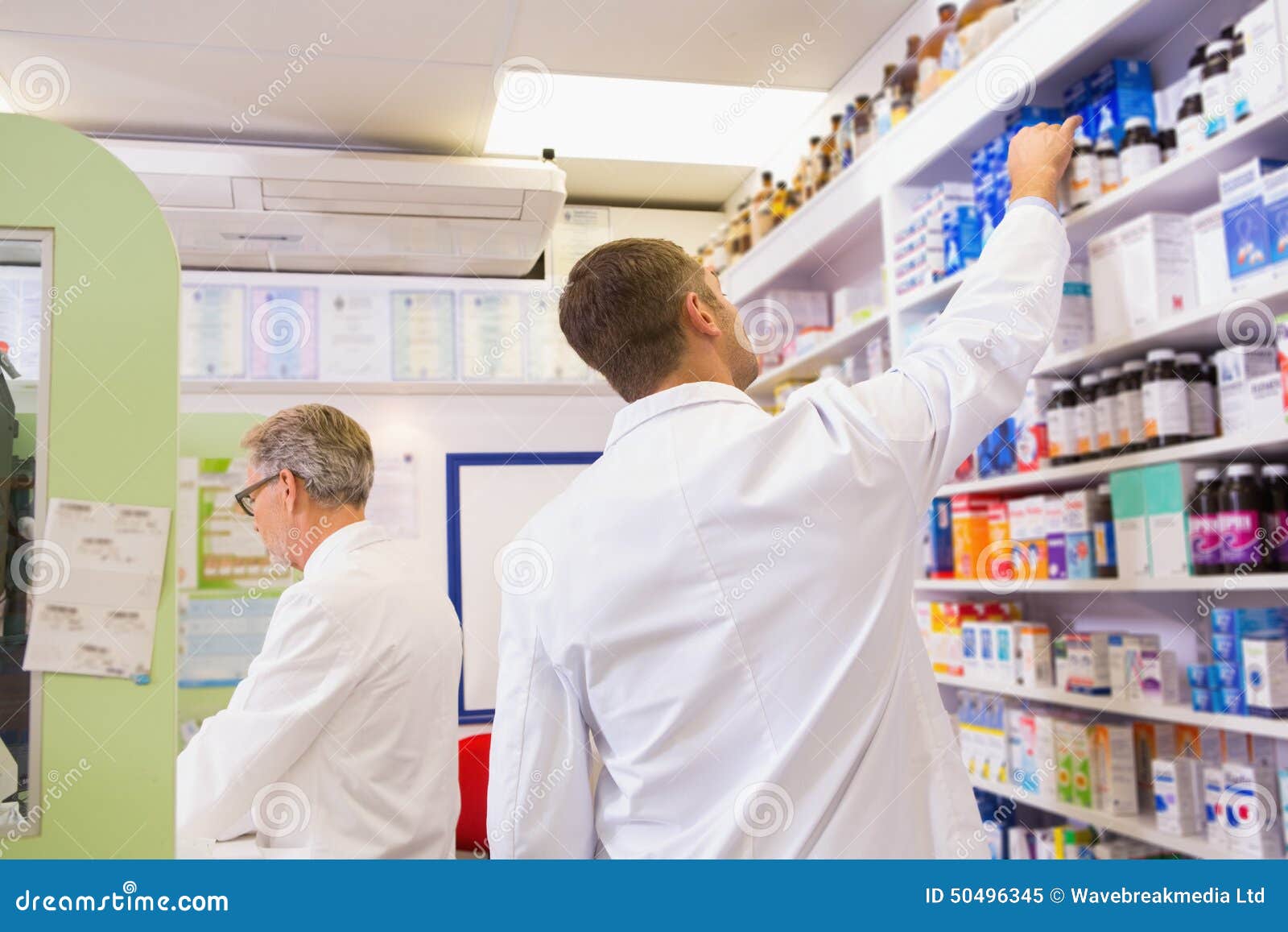 Pharmacist in Lab Coat Taking Jar from Shelf Stock Image Image of