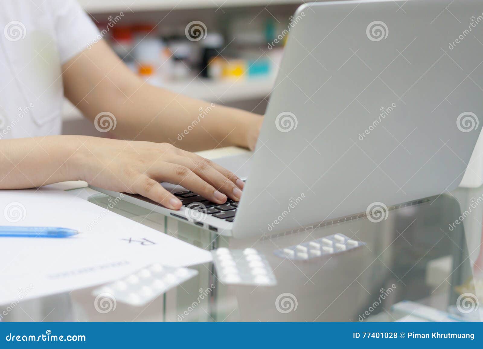 Pharmacist with Laptop Computer and Medication in the Pharmacy Stock