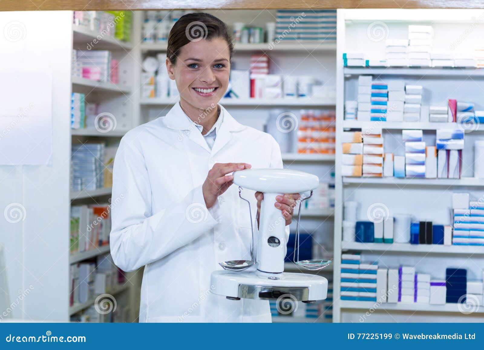 Pharmacist Measuring Tablets with Pharmacy Scale in Pharmacy Stock