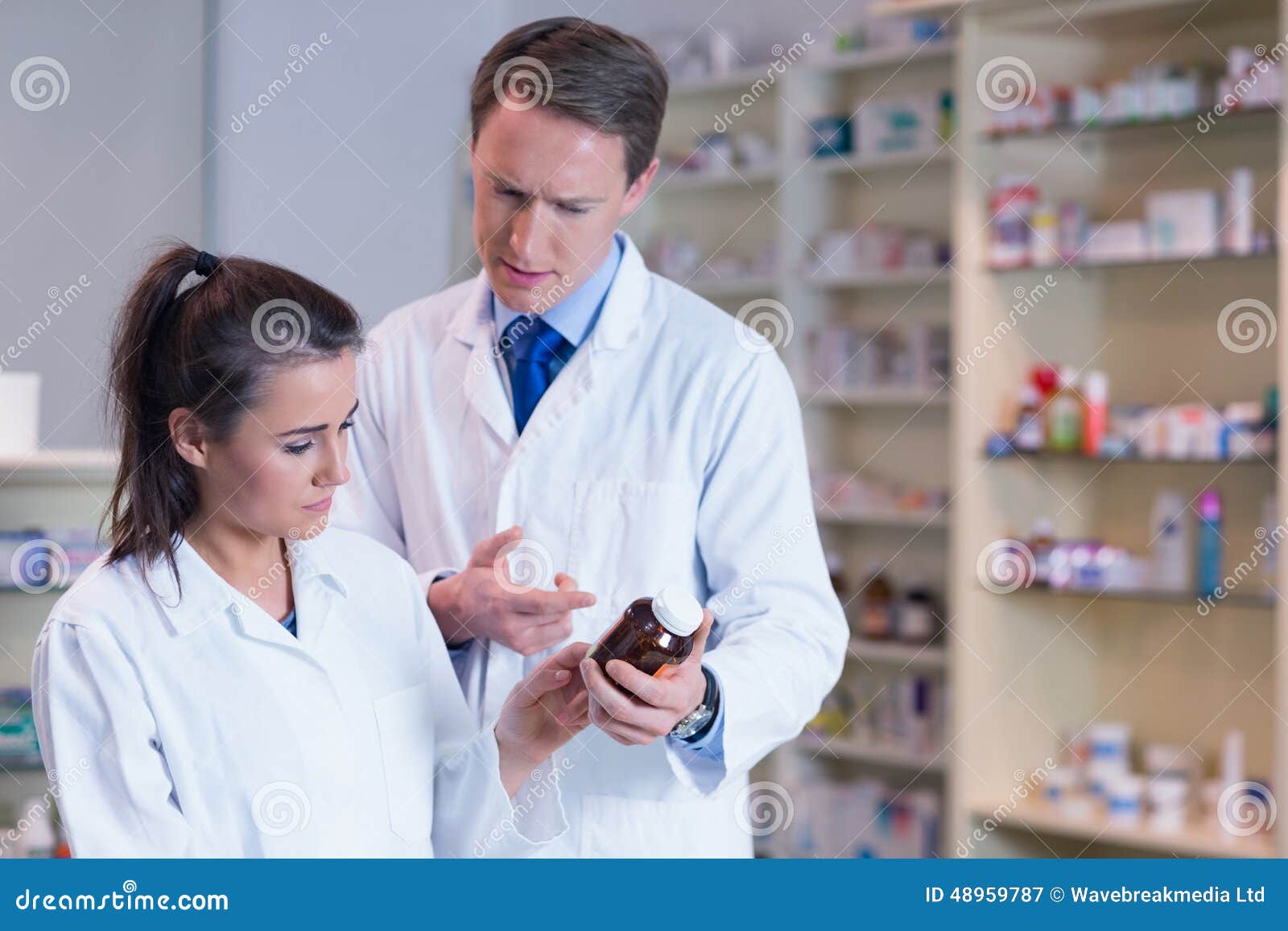 Pharmacist Showing Medication To His Trainee Stock Image Image of
