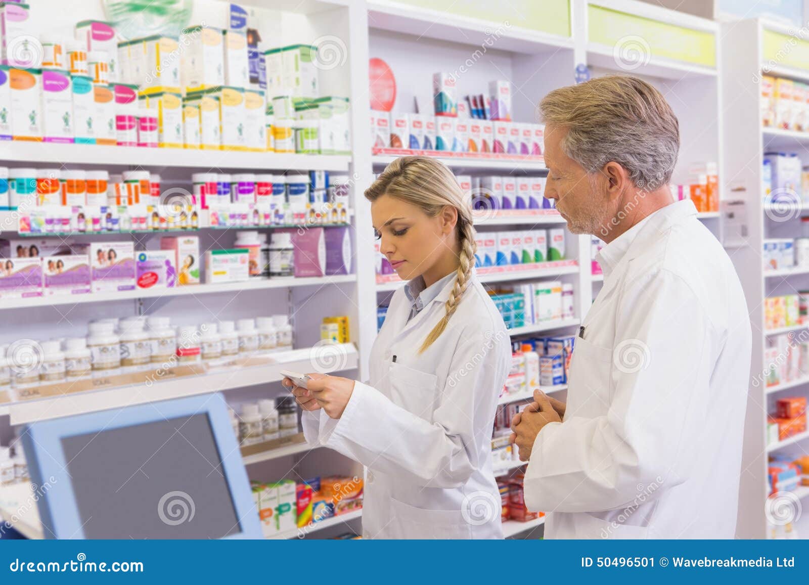Pharmacist Showing Medication To His Trainee Stock Image Image of drug, adult 50496501