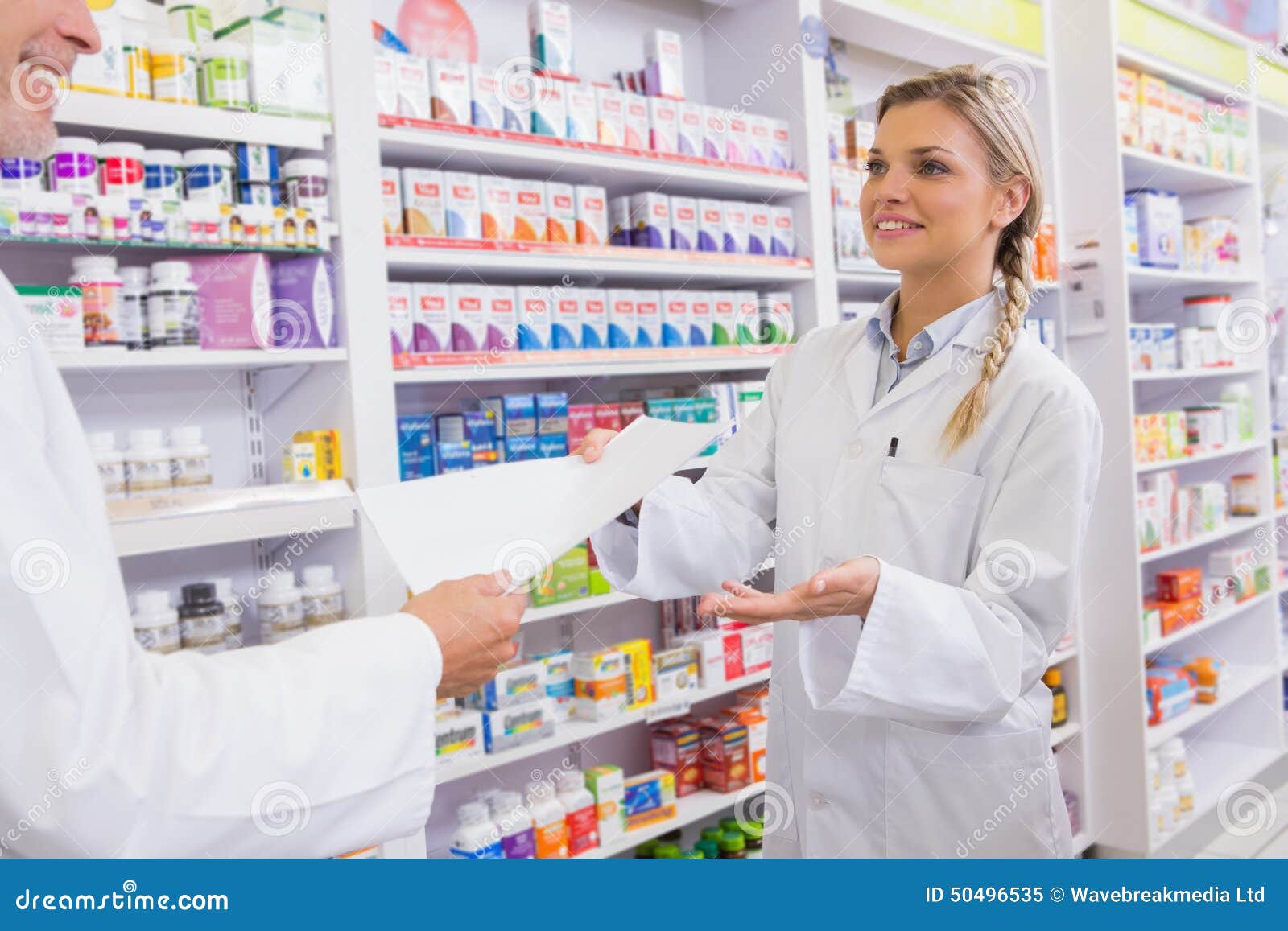 Pharmacist and Trainee Talking Together about Medication Stock Image
