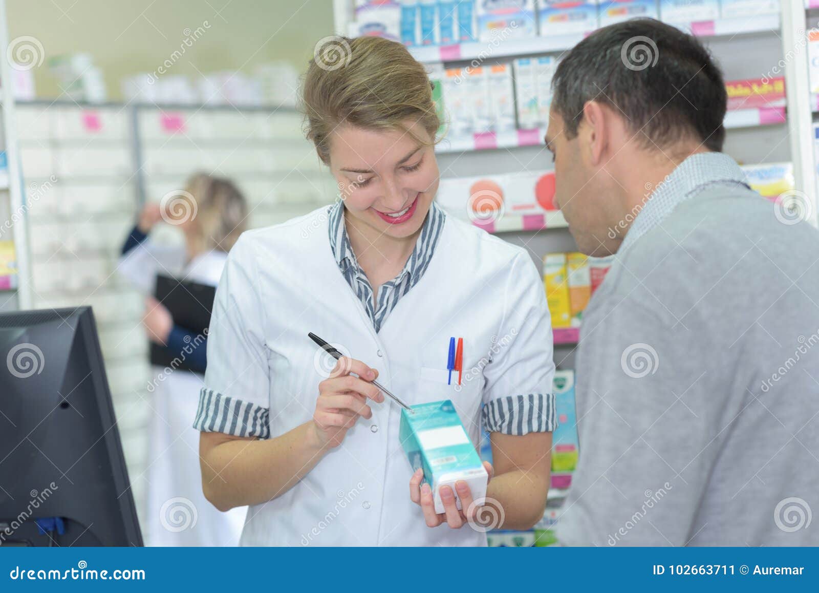 pharmacist writing dosage on box