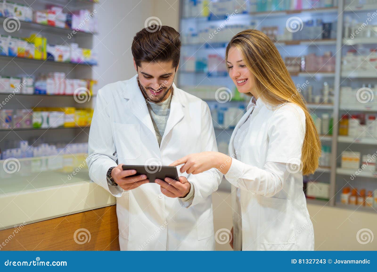 Pharmacists Using Digital Tablet while Checking Medicine Stock Image Image of device