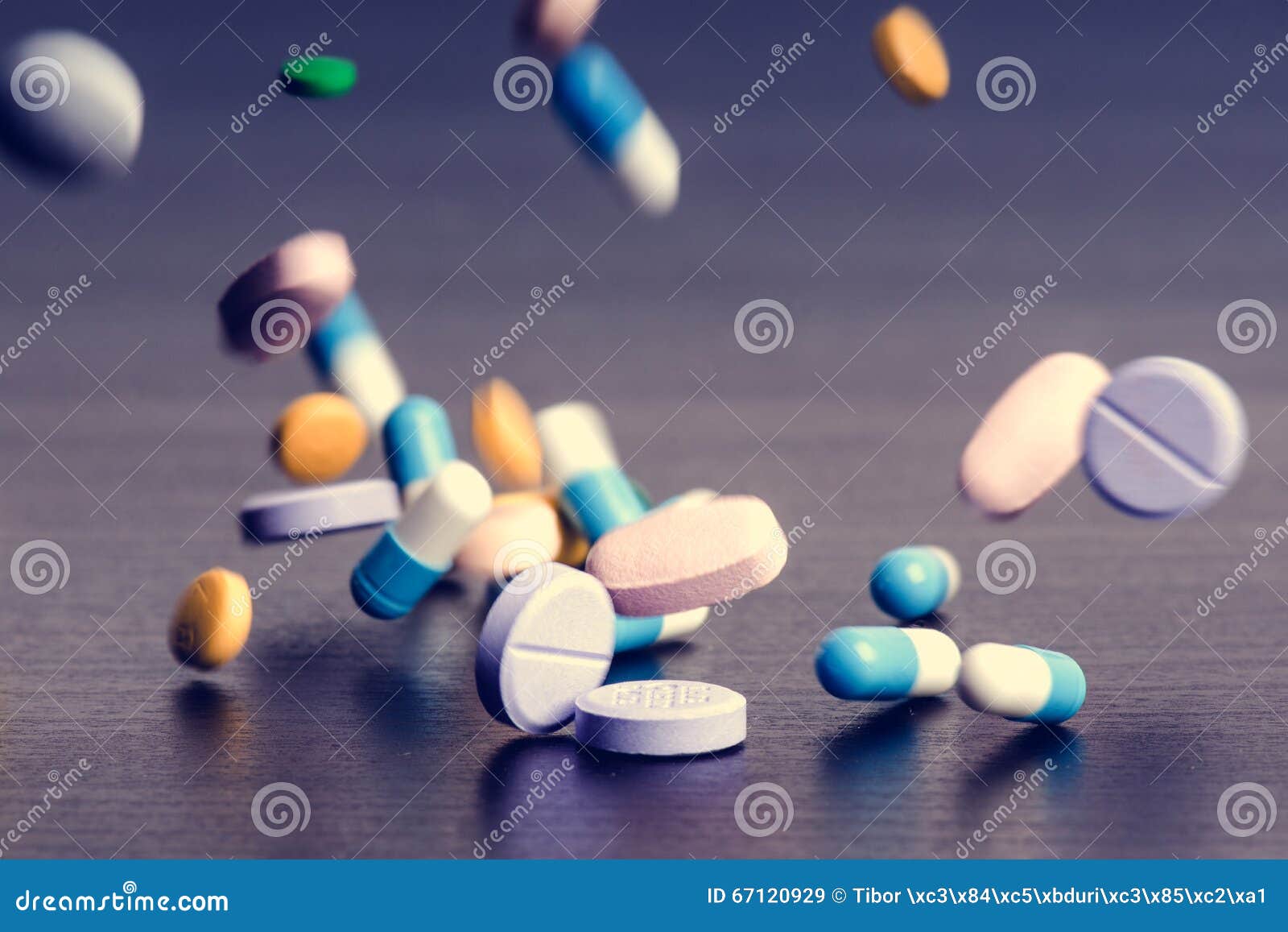 pharmacy background on a dark table. levitation pills. tablets on a dark background which falling down. pills. medicine and health