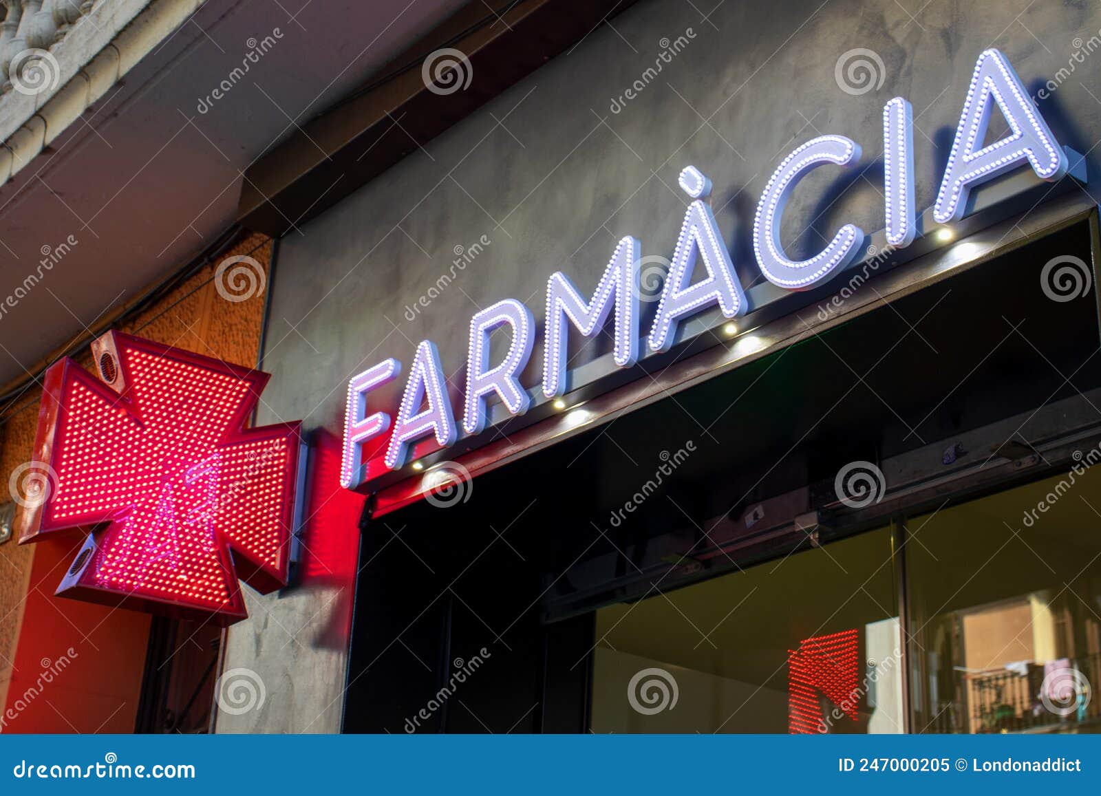 pharmacy in spanish for news. red led cross,  of health, medicine, self-care. farmacia sign in spain