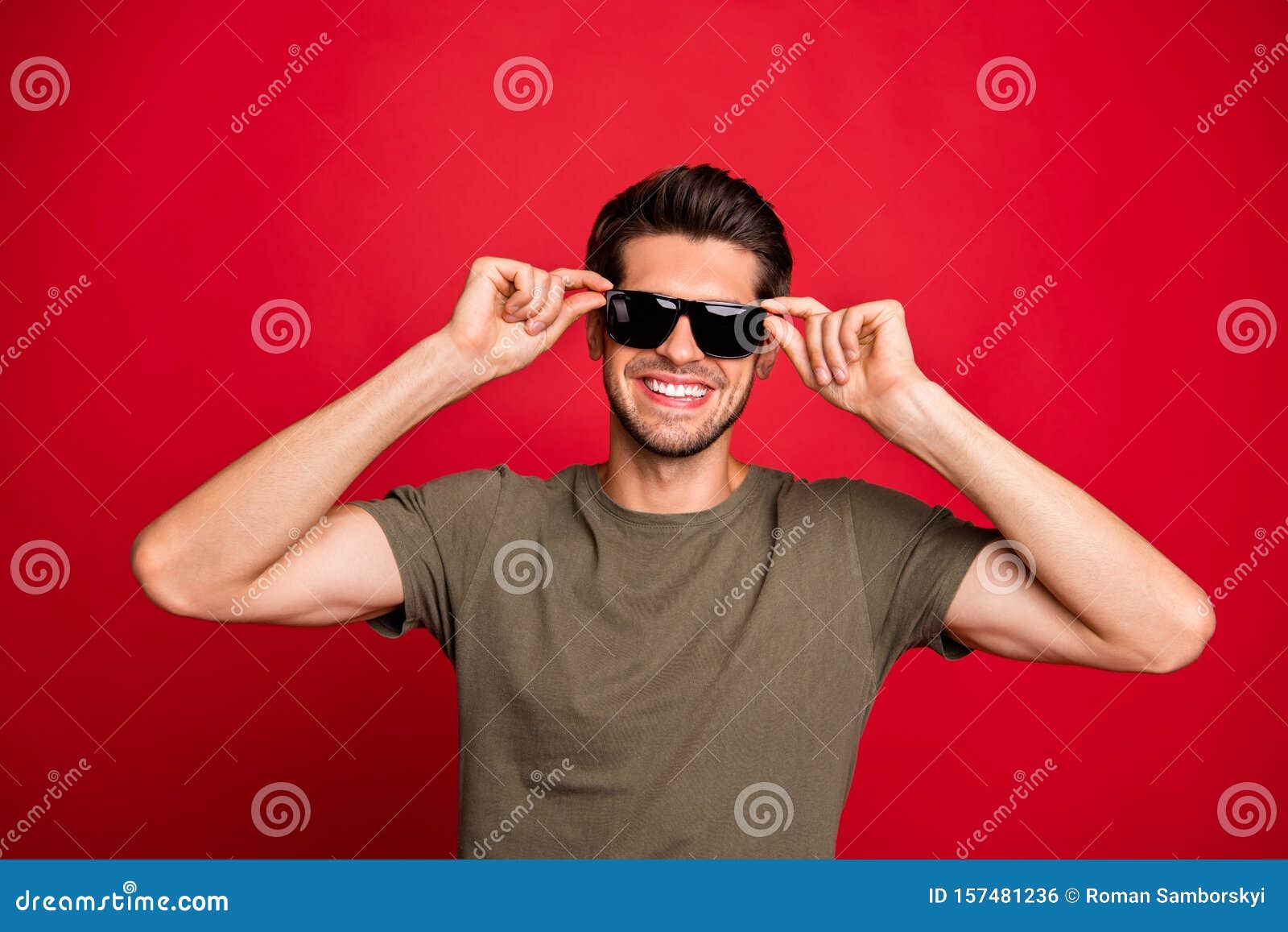 Photo of Amazing Guy Holding Sun Specs Hands Revealing White Teeth Wear ...