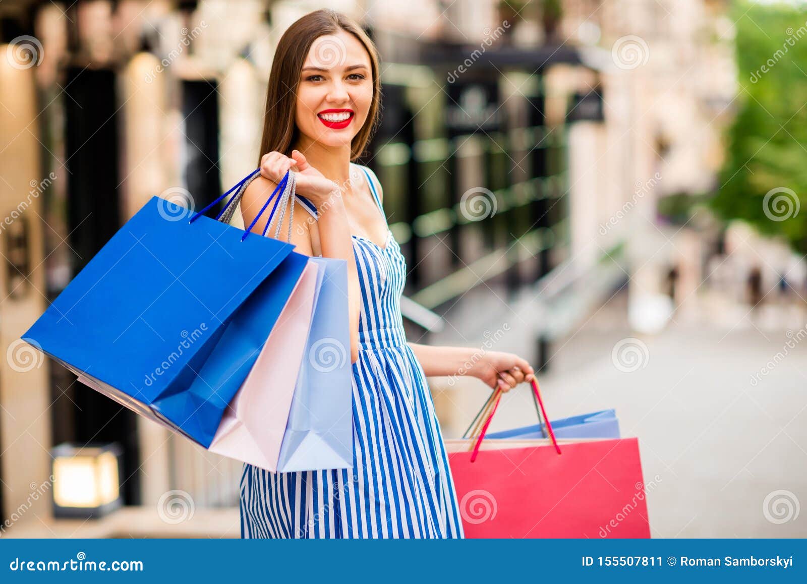 Photo of Beautiful Lady Visiting Different Shops Abroad Carrying Many ...