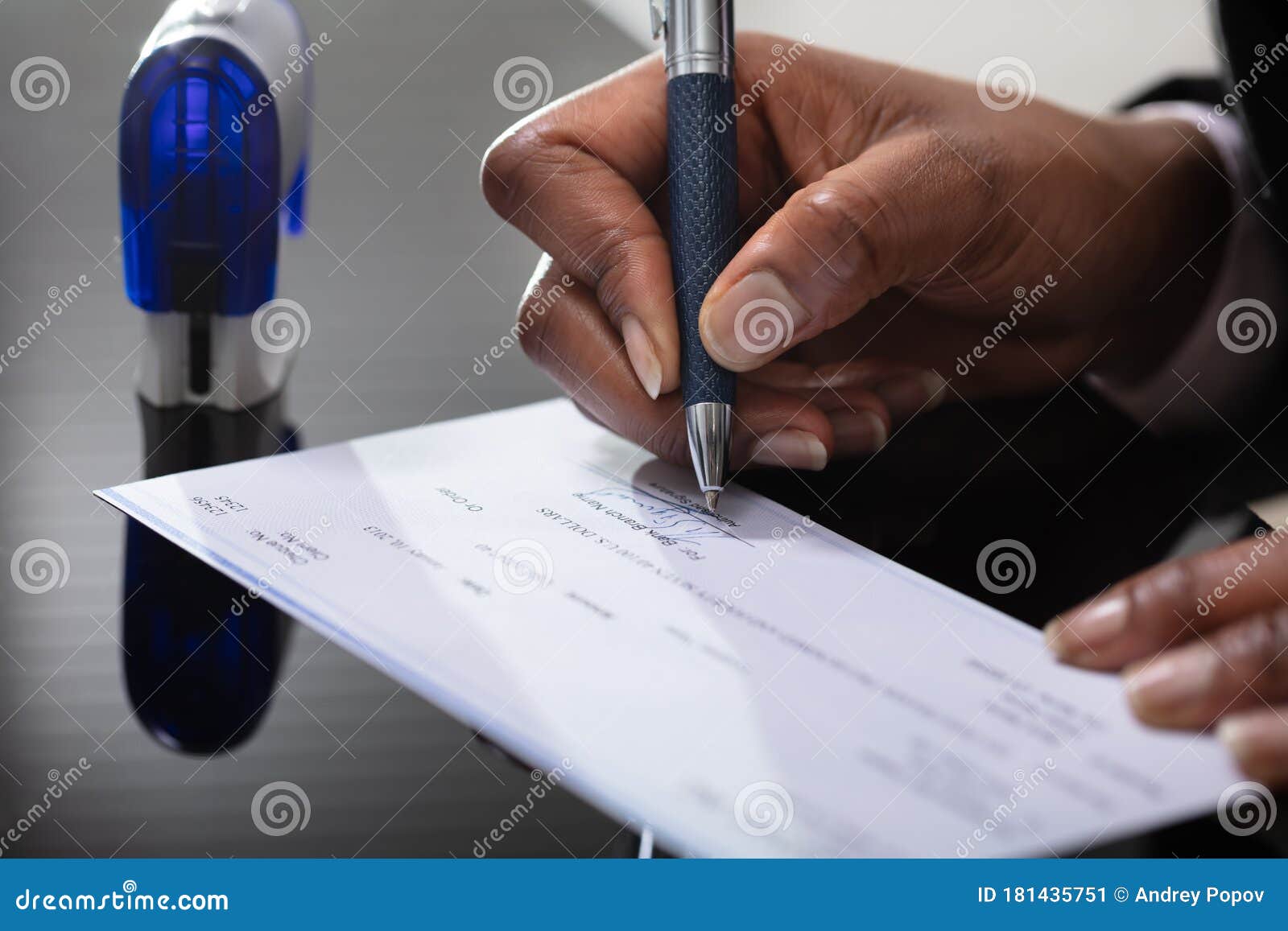 businessperson signing cheque