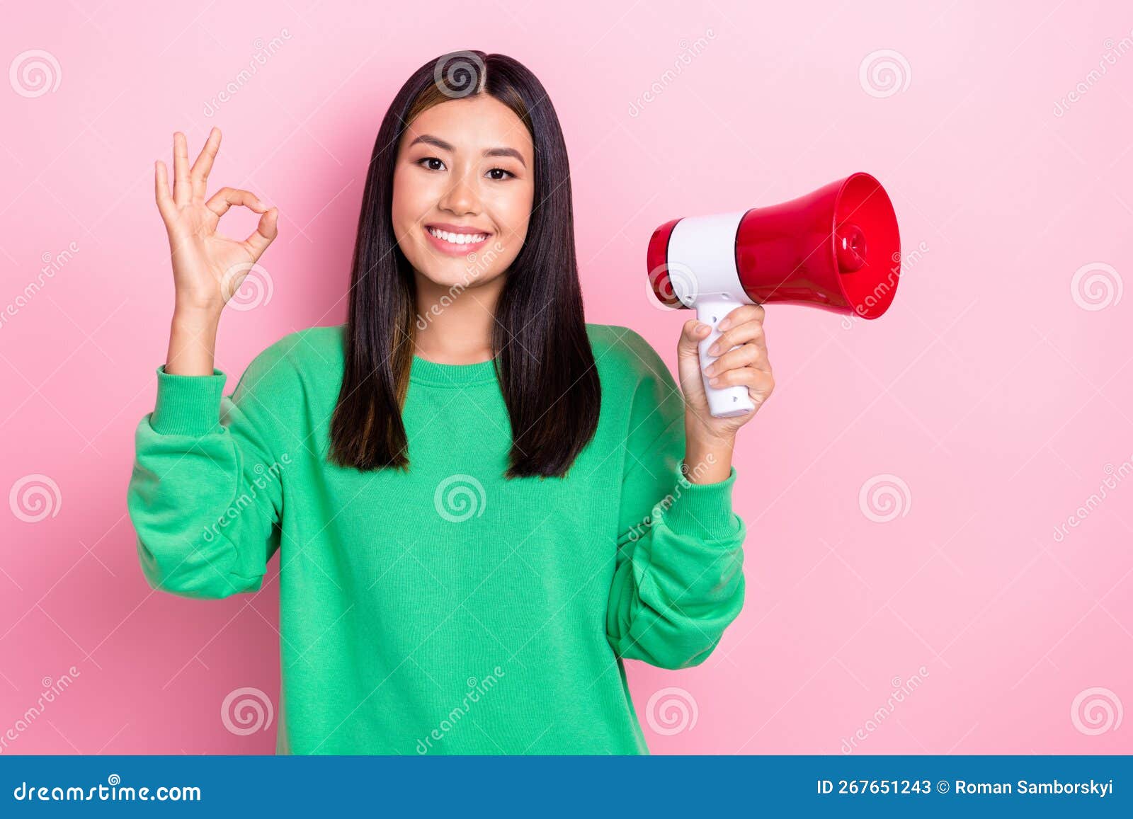 Photo of cheerful positive lady wear green sweatshirt showing okey holding bullhorn isolated pink color background.