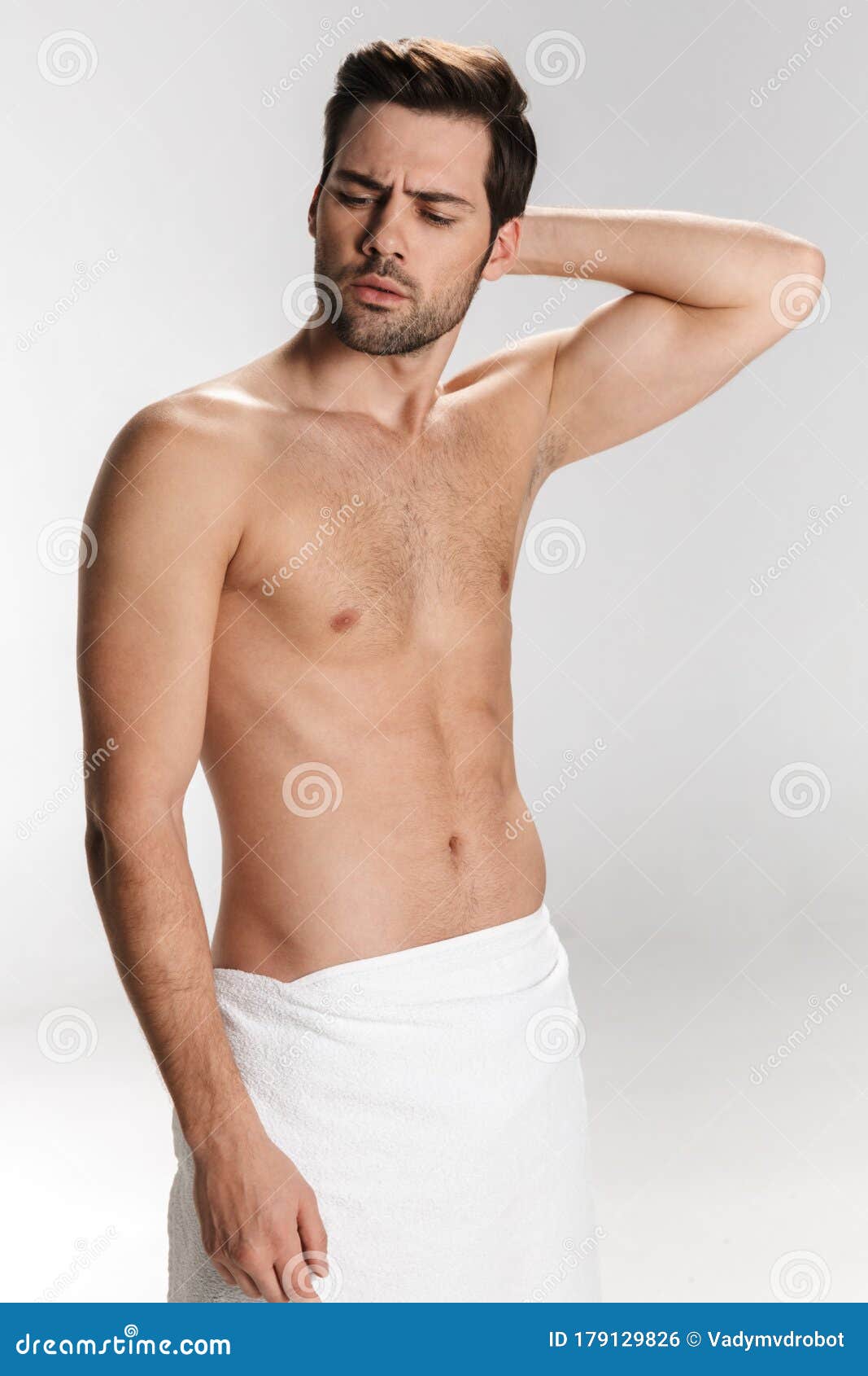 Photo Of Confused Half Naked Man Posing In Bath Towel Stock Photo
