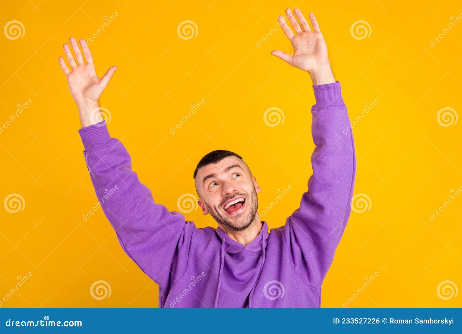 Photo of Cool Millennial Brunet Guy Hands Up Wear Purple Hoodie