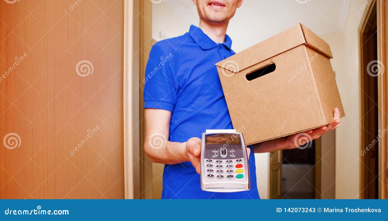 photo of courier man with cardboard box in hands and with terminal