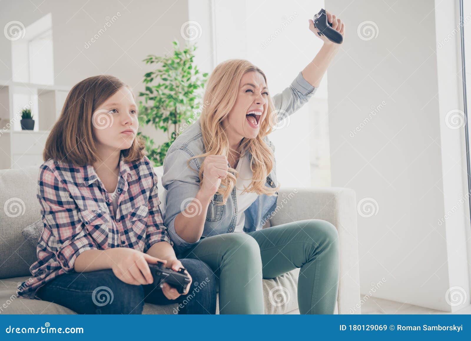Photo of Crazy Funny Blond Lady Yelling Mom Daughter Sit Sofa Hold Joystick  Play Video Game Winner Loser Stay Home Stock Image - Image of crazy,  people: 180129069
