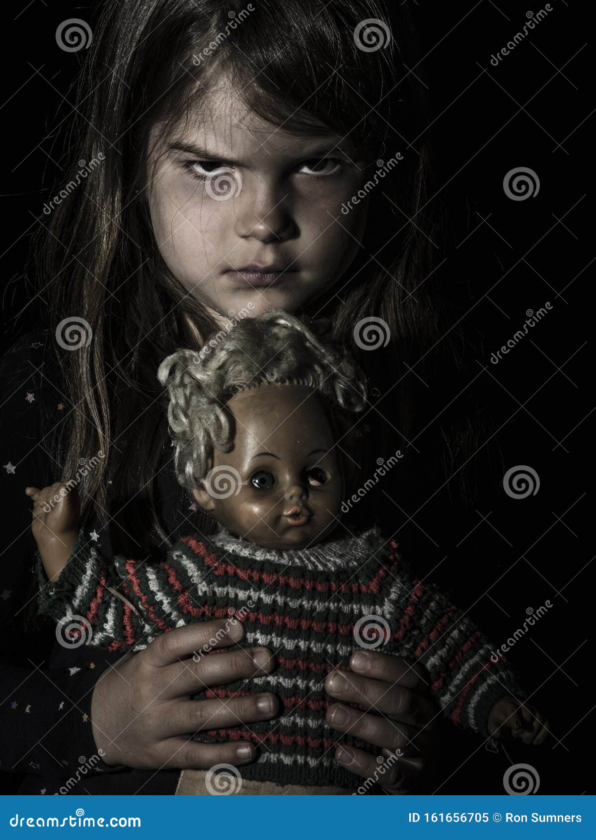 creepy girl with black hair and doll