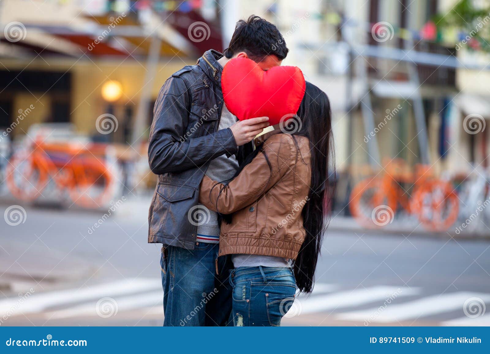 Photo Of Cute Couple Holding Heart Shaped Pillo