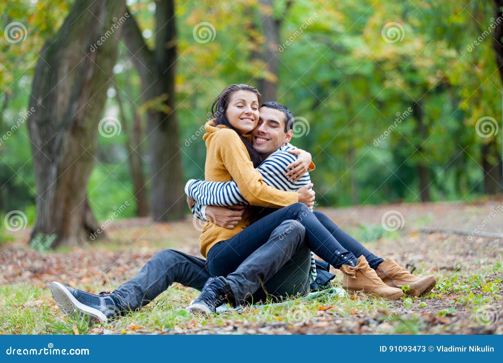 Photo of Cute Couple Hugging on the Ground on the Wonderful Autu ...