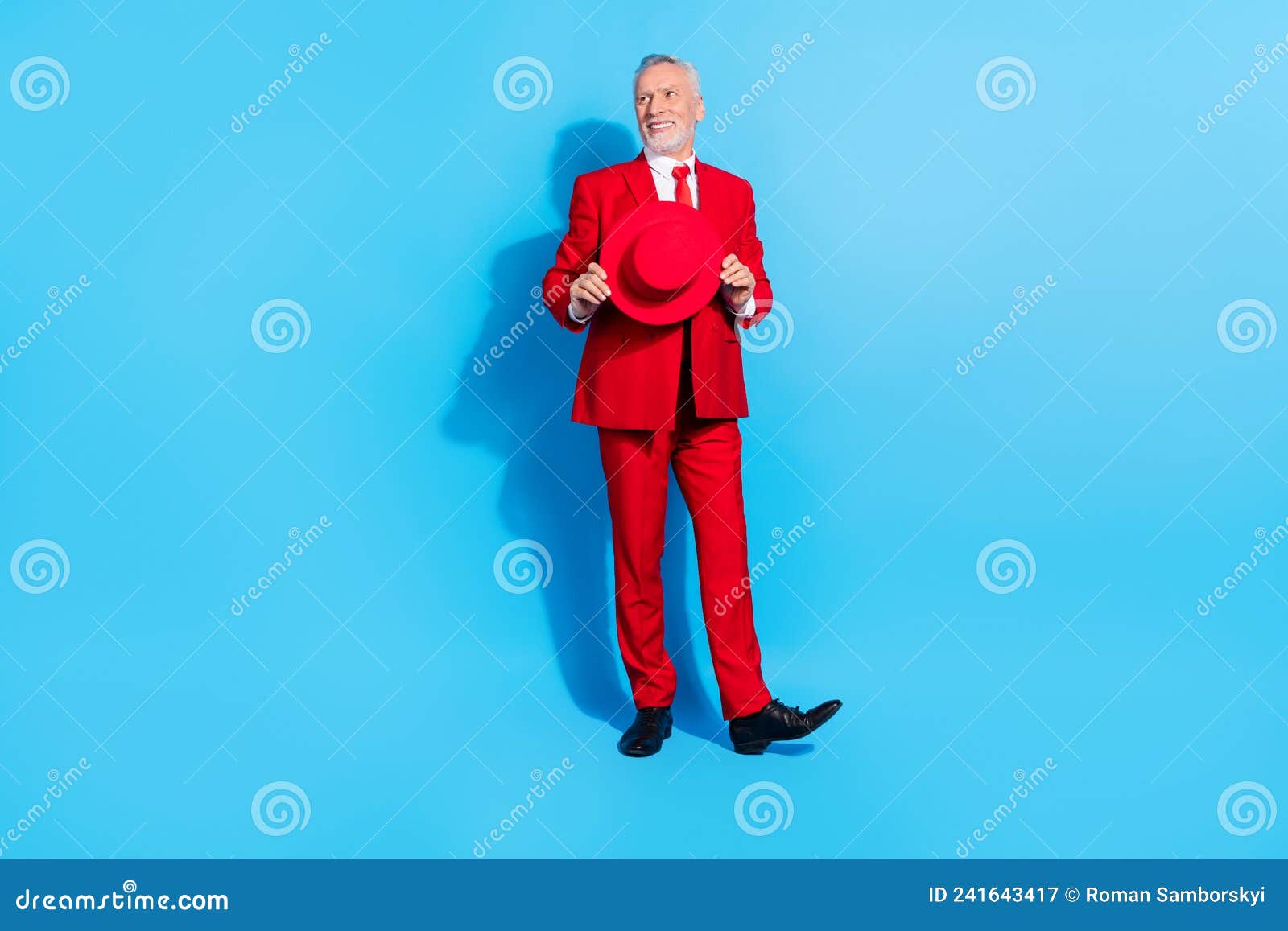 photo of dreamy inspired pensioner man look empty space hold hat wear red suit shoes  blue color background