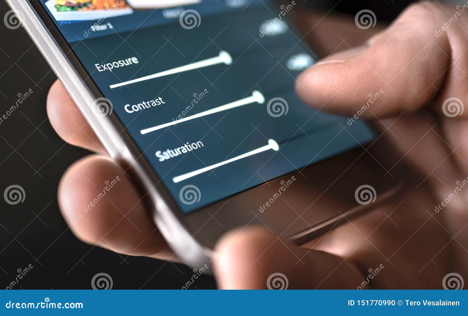 photo edit with mobile phone and smart app. man adjusting sliders. image editing, manipulation, improvement or enhancement.