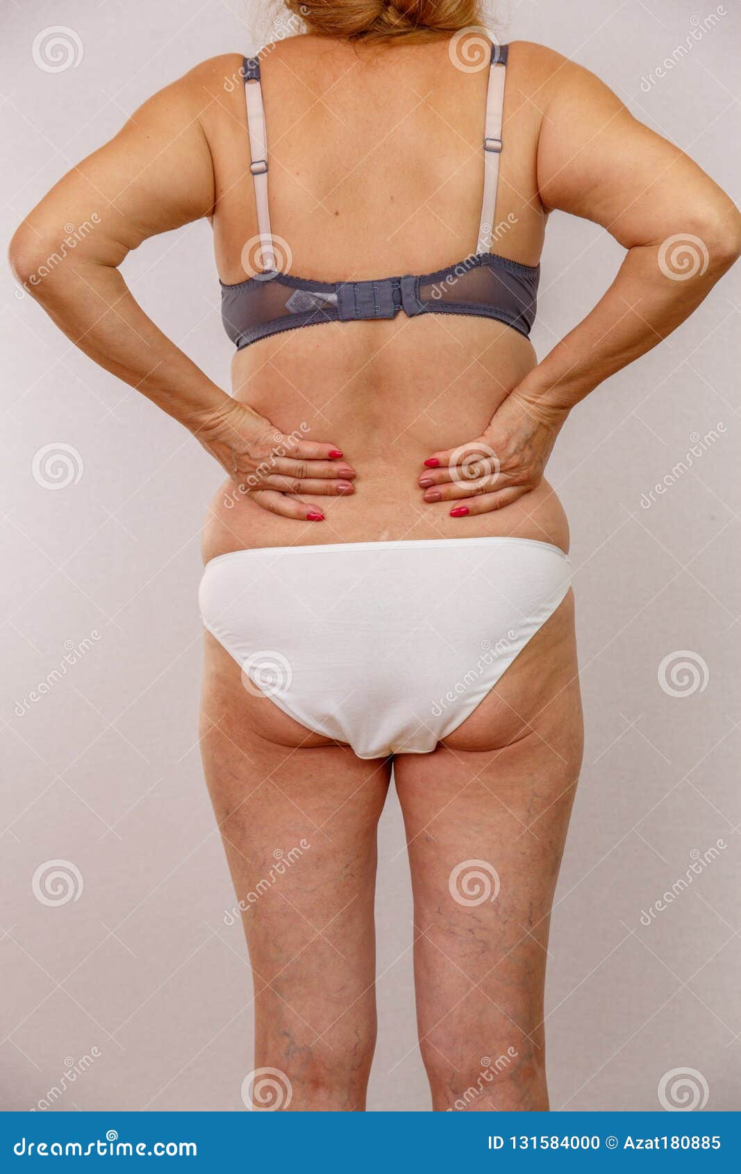 Photo of an Elderly Woman in Underwear on a White Isolated